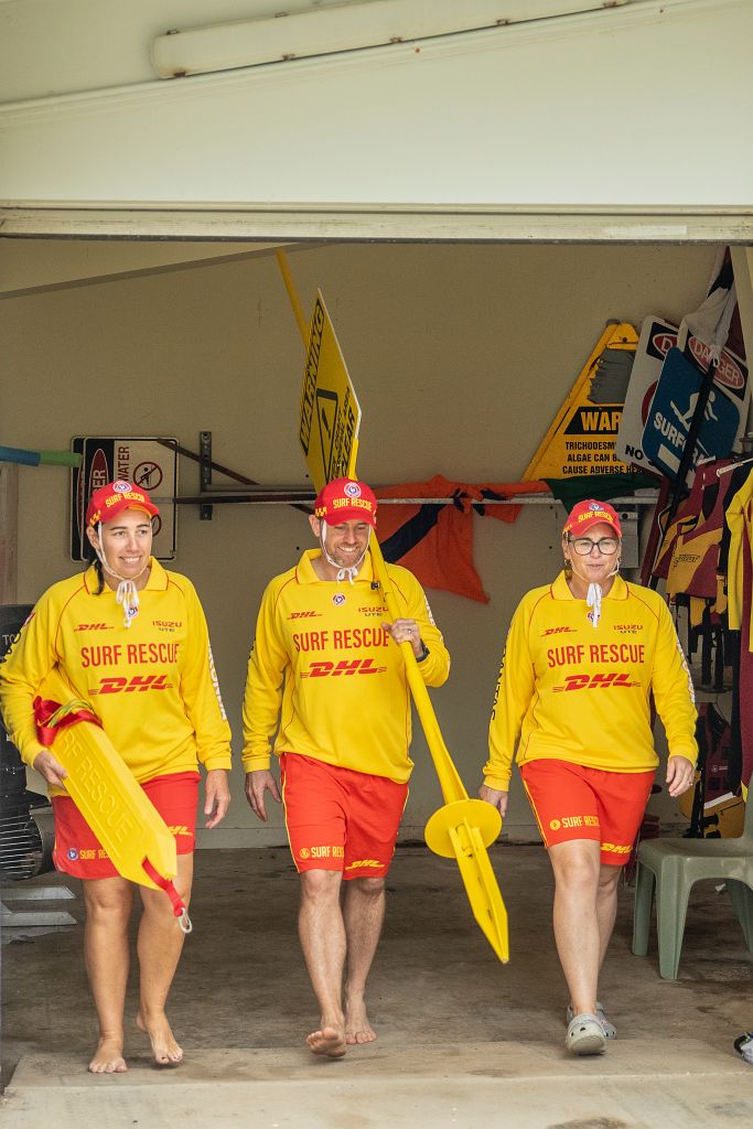 Lifesavers walking with rescue boards at Coochiemudlo SLSC
